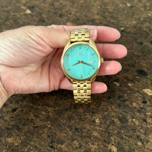 Nixon “the bullet” gold watch with turquoise face